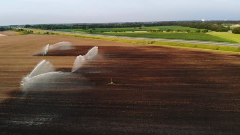 rainbow glittering in the water spray of an industrial plantation sprinkler