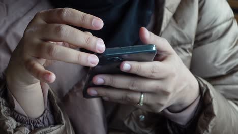 woman using smartphone in a cafe