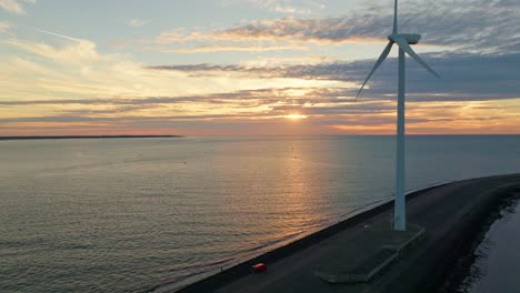 Drone-shot-of-a-wind-turbine-on-Neeltje-Jans-island-during-sunset