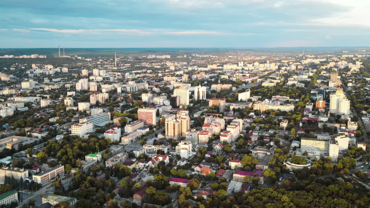 Aerial drone view of Chisinau, Moldova at sunset. Buildings, roads, greenery, cloudy sky