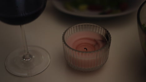 blown out decorative candle on table with festive setting