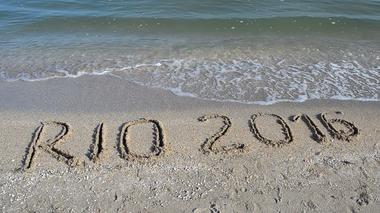 Rio 2016 an inscription on sand, the beach. Symbol Olympic game on sand, the beach