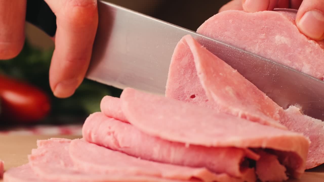 Ham italian mordatella, man Slices Of Traditional Italian antipasti mortadella sausage on a wooden cutting board, close up macro of chicken or turkey jamon, fat breakfast dish.