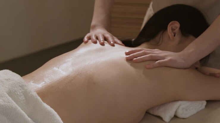 A person receiving a relaxing back massage at a spa