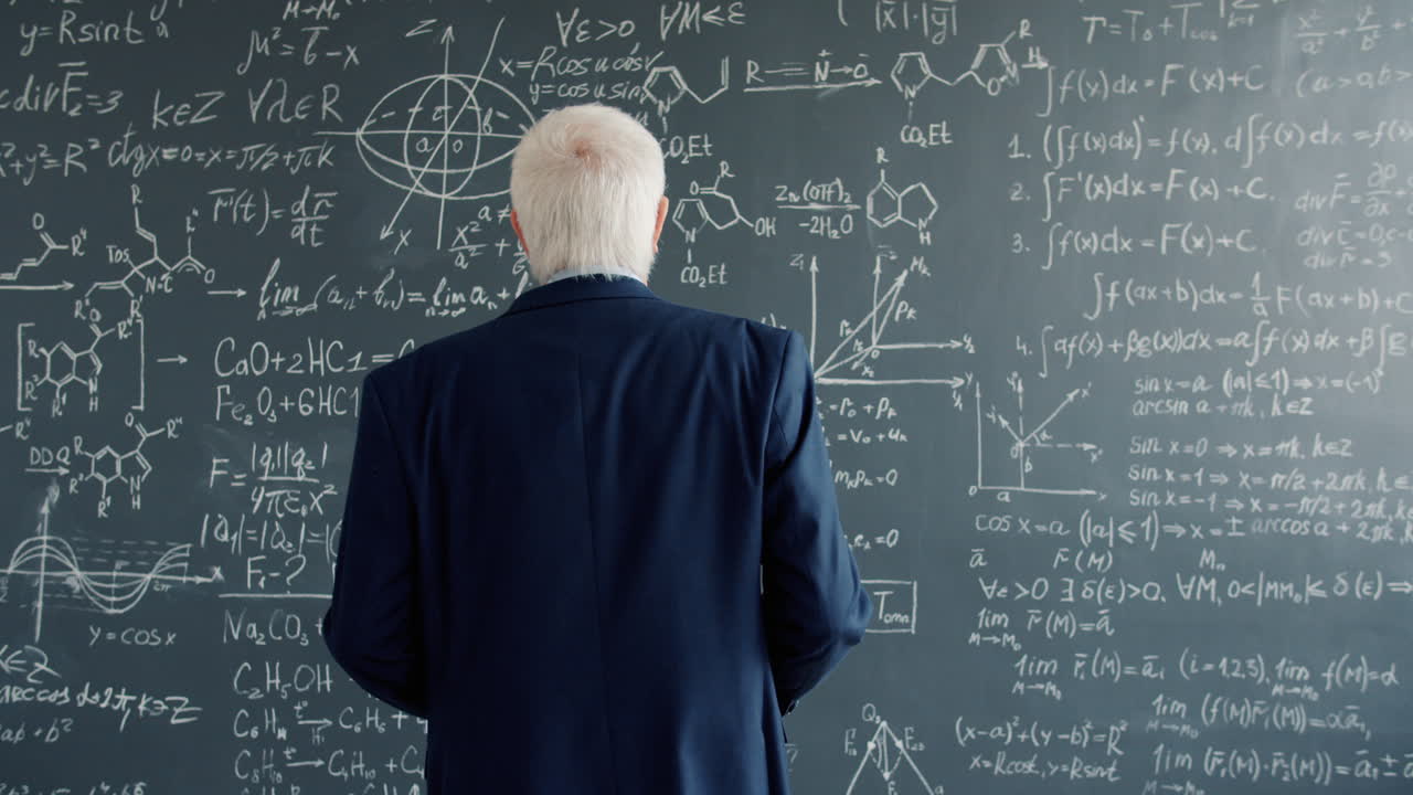 Professor Looking at a Blackboard Full of Equations