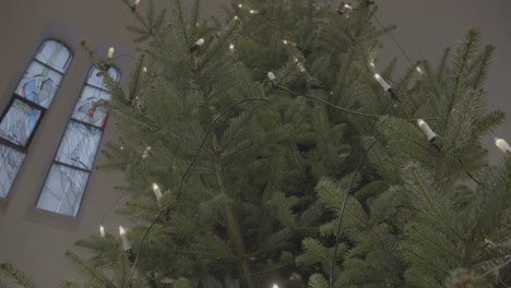 christmas tree with electric candles in the sanctuary of a church