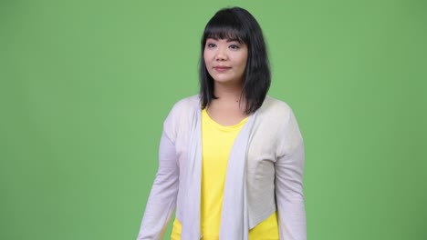 beautiful happy asian woman smiling while giving thumbs up