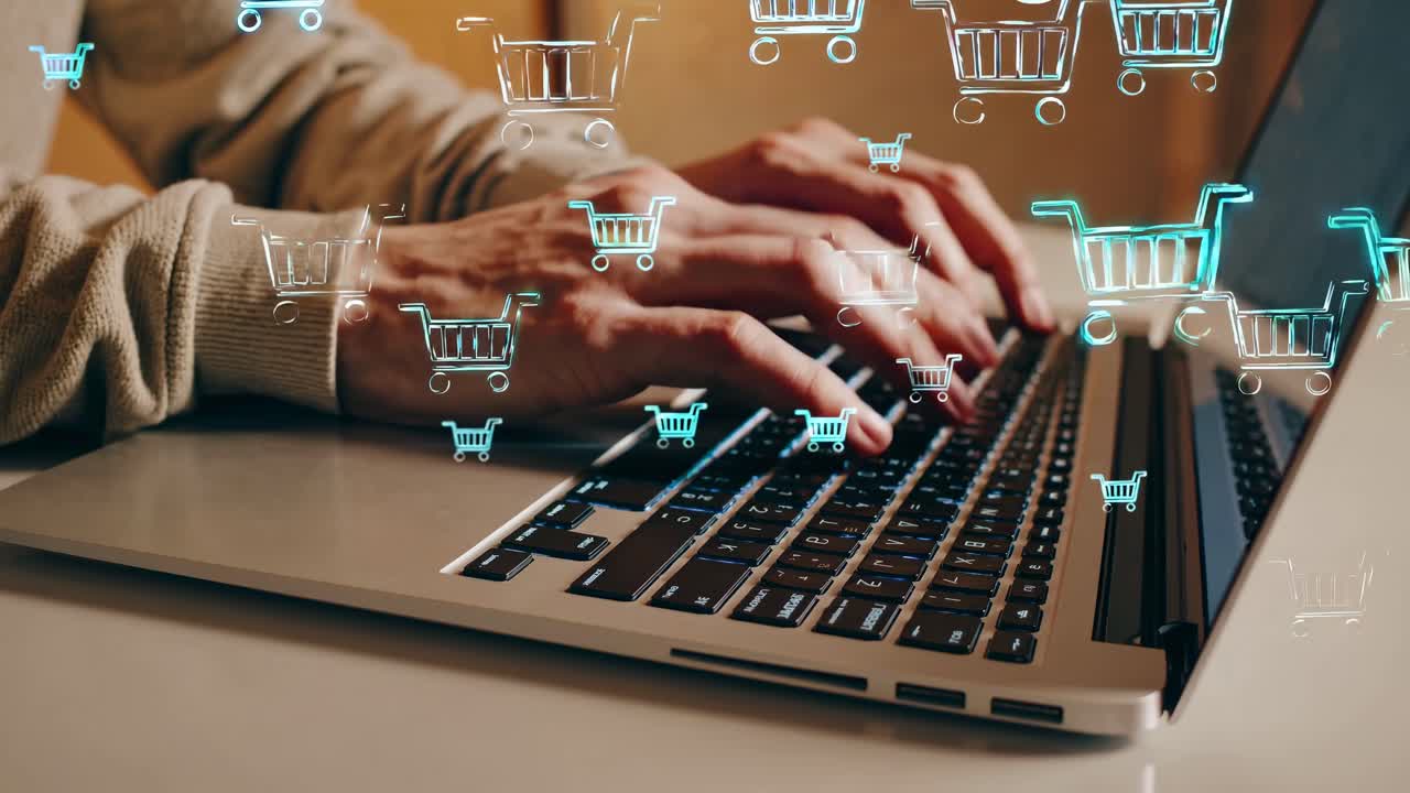 A close-up angle of hands typing on a laptop, surrounded by digital shopping cart icons