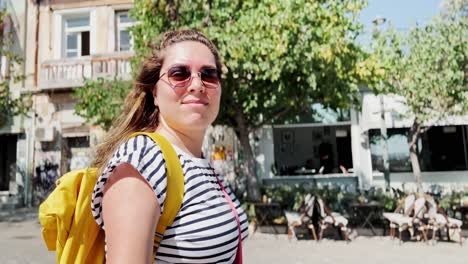 female tourist walking on a busy street in athens