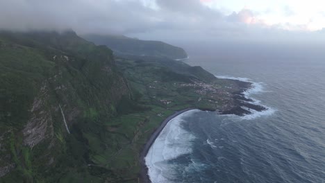 panoramic view of small town fajã grande during cloudy day - drone shot