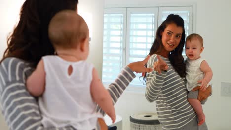 Mom-playing-with-her-baby-in-bathroom