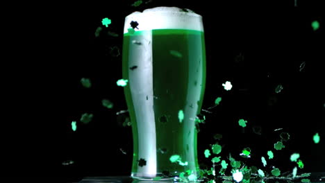 shamrock confetti next to a pint of green beer