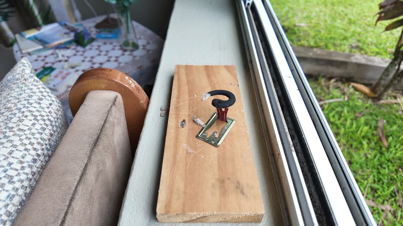A close-up view of a wooden block with a candle on a window sill, captured in hyperlapse