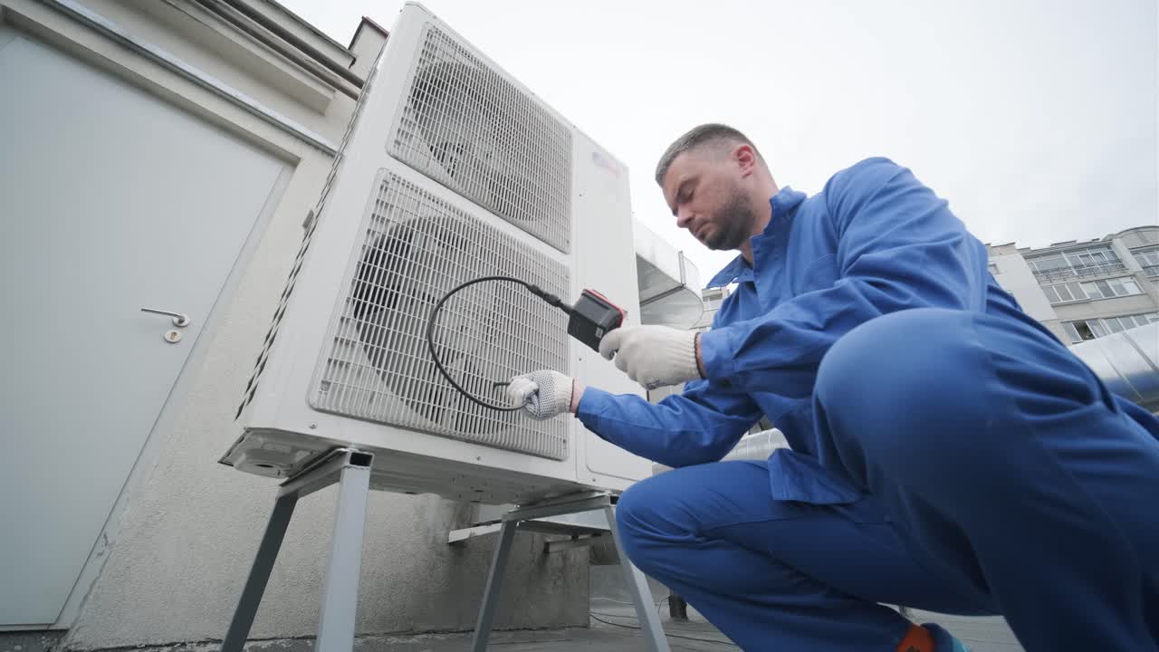 The technician uses a digital camera to check the clogging of the heat exchanger