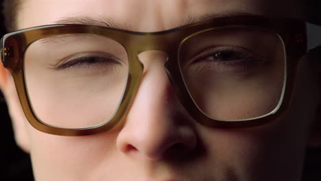 portrait of focused young business woman closing eyes in glasses in office.