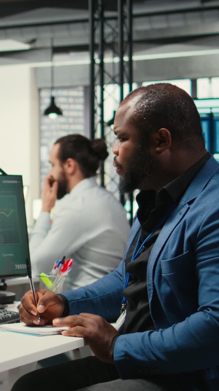 Vertical Video Black employee building new development strategy with notes