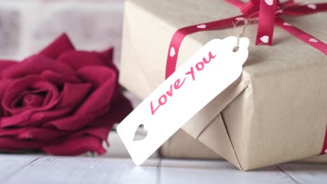 gift with love message and red rose