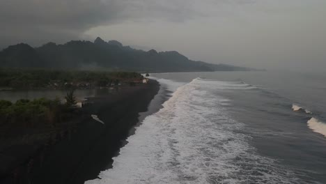 landscape of volcanic black sand beach in java, indonesia, aerial shot