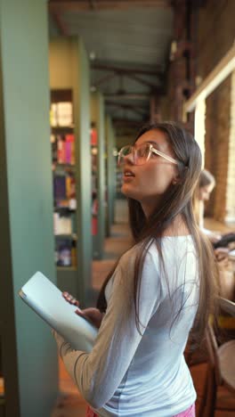 woman in library with laptop