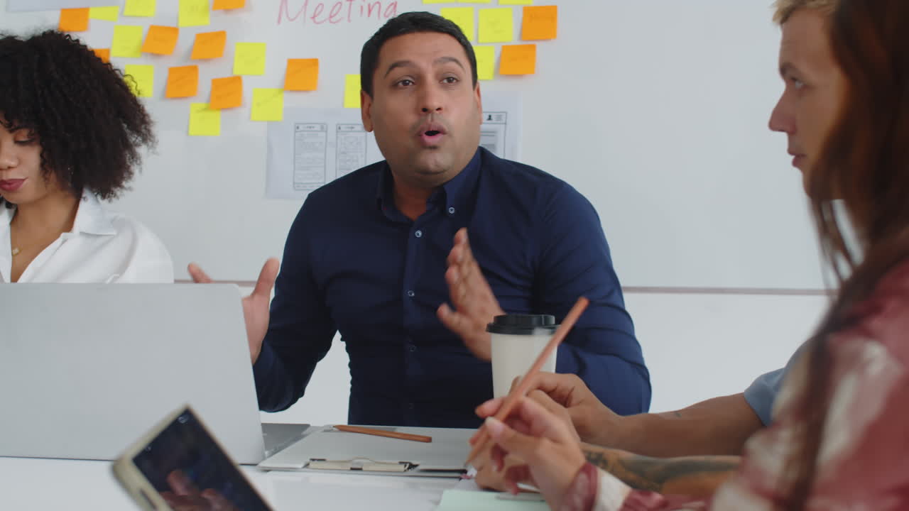 Colleagues Listening to Product Manager during Meeting