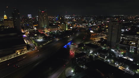 A-nighttime-aerial-establishing-shot-of-the-city-of-San-Antonio,-Texas