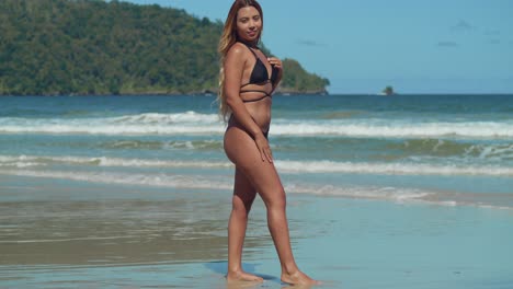 savoring the tropical vibes, a young girl of hispanic origin delights in a caribbean beach in her bikini