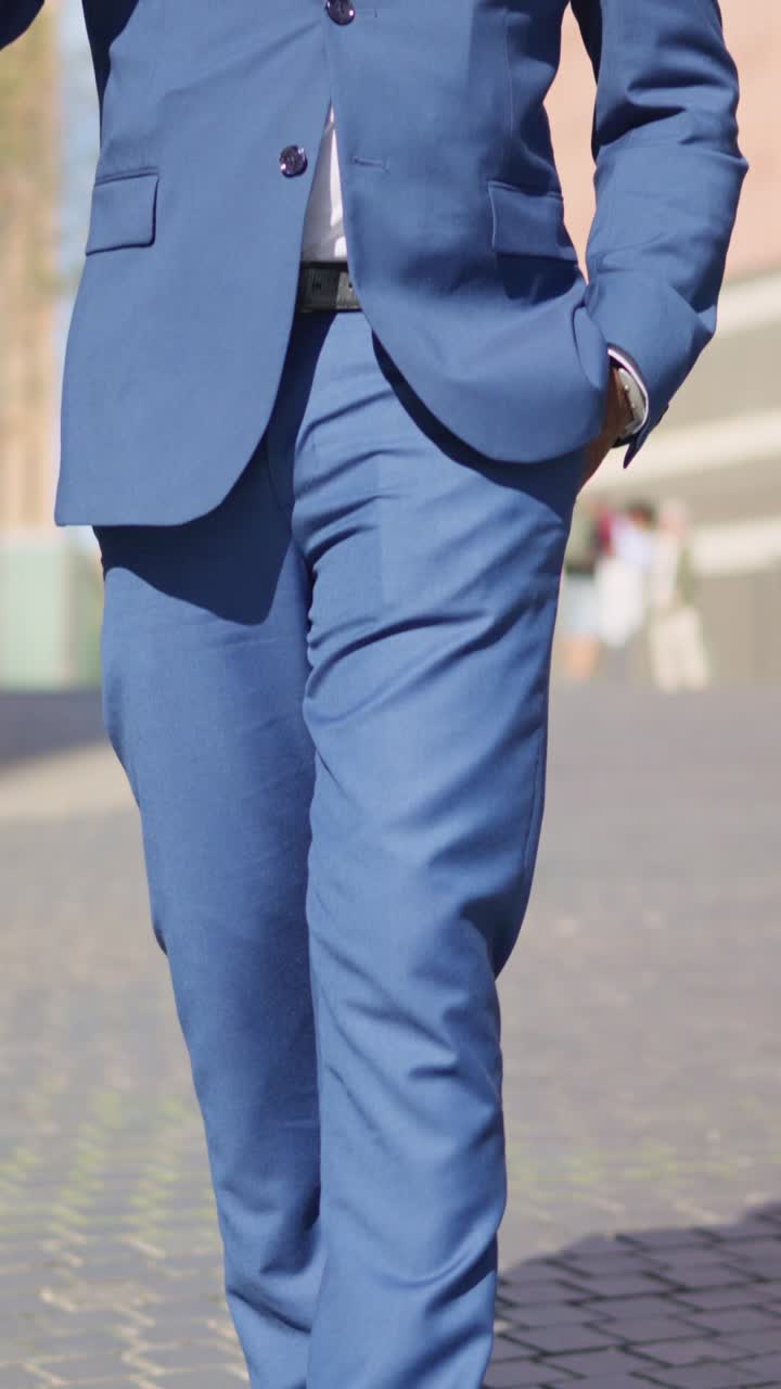 Close-up of a man in a blue suit and dress shoes