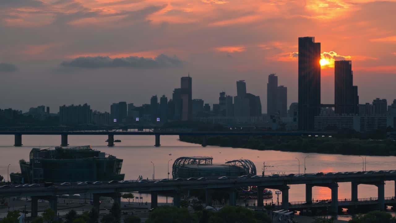 Aerial real time view of dramatic sunset next to Raemian Caelitus Tower 101 skyscraper above Banpo Bridge with Han River and Some Sevit islands in silhouette