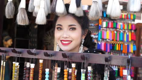 beautiful woman smiling in souvenir shop, slow motion