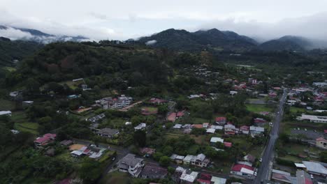 aerial view of a town nestled in a lush mountainous landscape