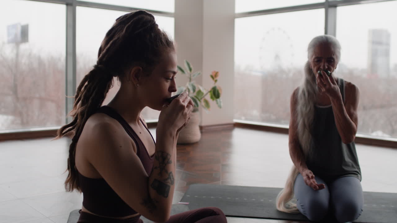 Young and Older Women Meditating and Drinking Tea