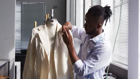 mixed race man working in fashion office