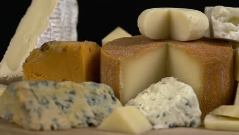 close up low angle narrow focus cheese assortment rotating on board