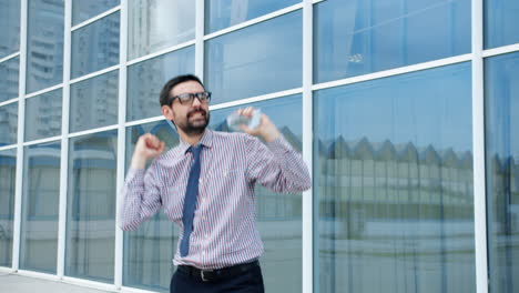 businessman celebrating success outside office building