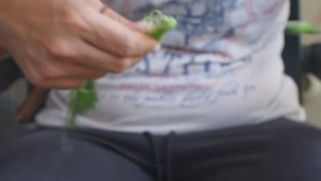 Woman-prepares-zucchini-flowers-for-traditional-kalamata-food-outdoors