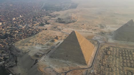 Aerial-view-showcases-the-majestic-Great-Pyramids-of-Giza,-the-Pyramids-Plateau,-and-the-iconic-Sphinx-in-Egypt,-embodying-the-concept-of-ancient-wonder-and-timeless-grandeur