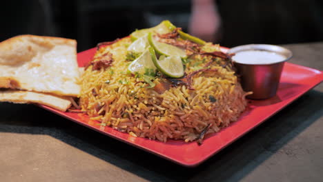 montón de biryani cubierto con chiles y limas plato tradicional indio, deslizador de órbita cámara lenta hd