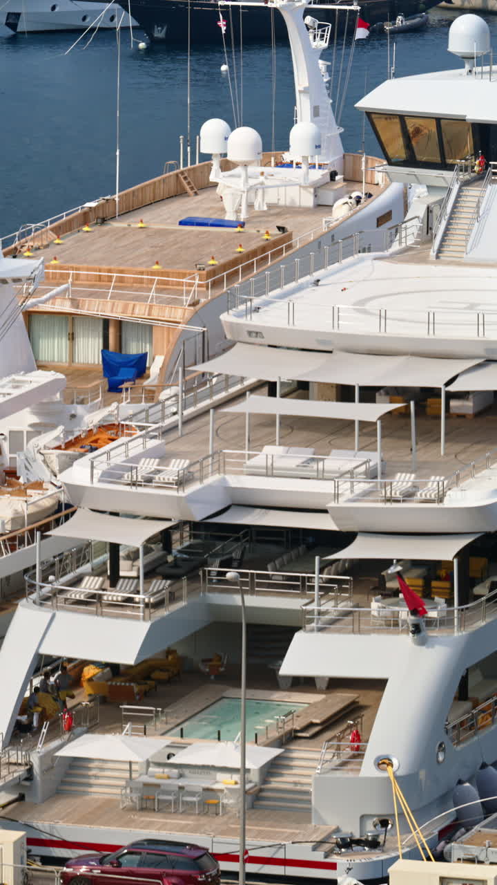 View of white yacht docked in the Monaco Marina. Vertical