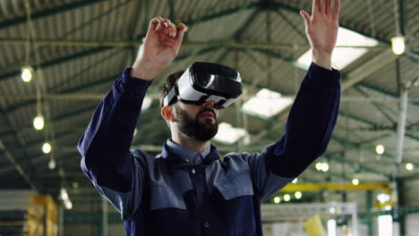 male factory worker wearing vr headset in a big factory