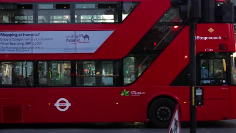 red bus and cyclists on busy london street