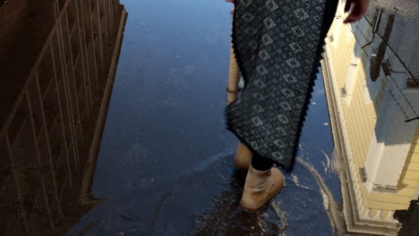 Old-steel-plant-cooling-tower-reflecting-in-the-puddle---Resita,-Romania