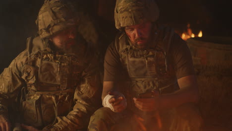 soldiers discussing near campfire at night