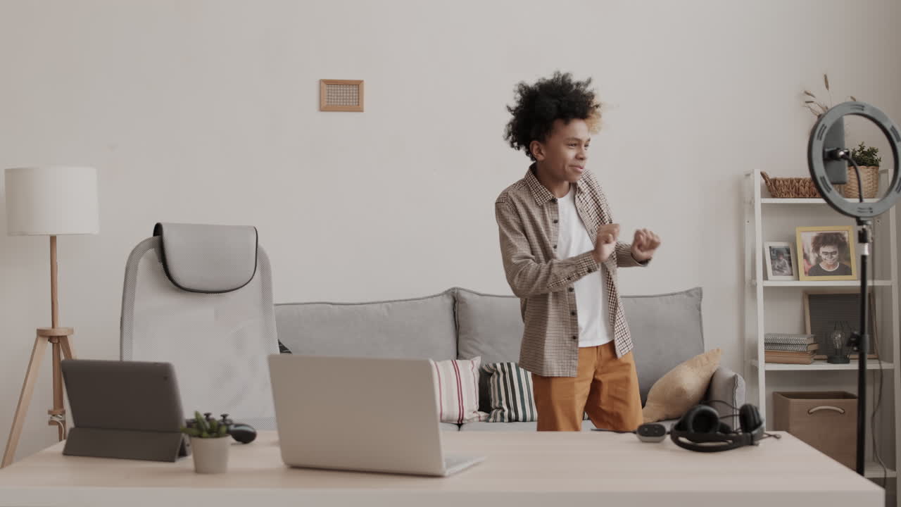 Teenage Boy Filming Dance on Smartphone