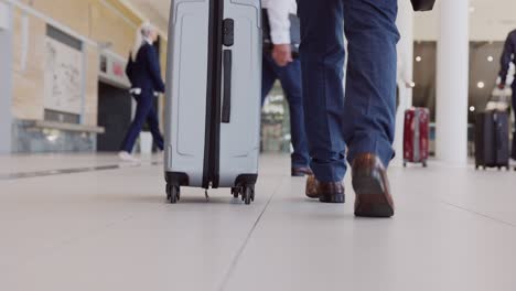 passenger with his trolley walking in airport