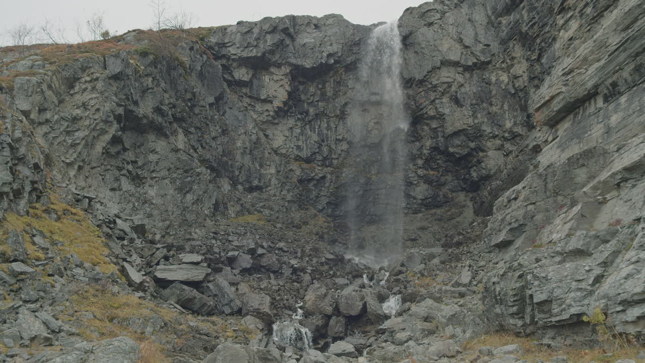 Waterfall in northern Lapland in rugged environment in slow motion