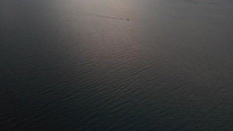 beautiful-areal-shot-of-Como-lake-in-Italy,-with-clear-water-and-small-waves-floating-in-4k-while-sunset