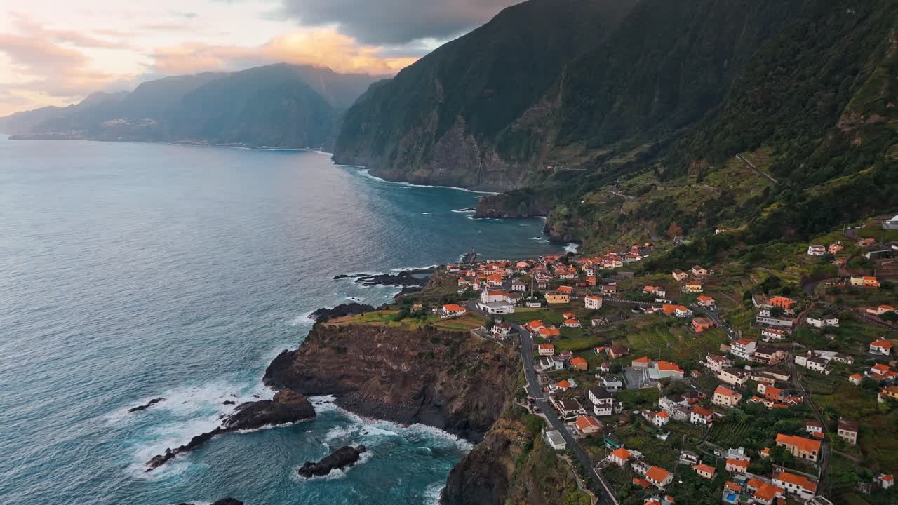 Witness the enchanting Seixal Coast at sunset through stunning drone footage capturing the coastline’s golden glow.