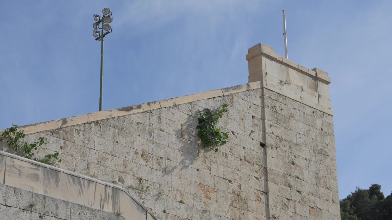 Detal zewnętrznej ściany z marmurowych bloków historycznego Stadionu Panatenajskiego w Atenach, Grecja. Ujęcie z podniesieniem kamery