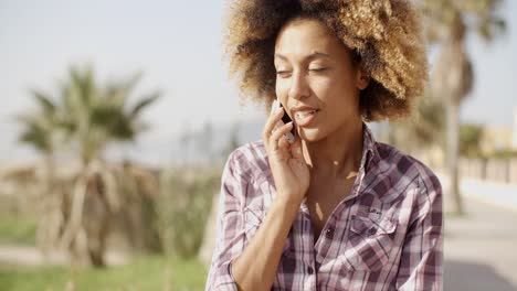 Smiling-Woman-Talking-On-Cell-Phone