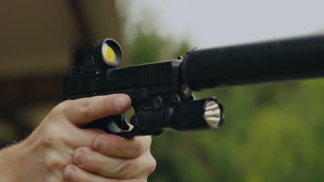 man with a gun and silencer